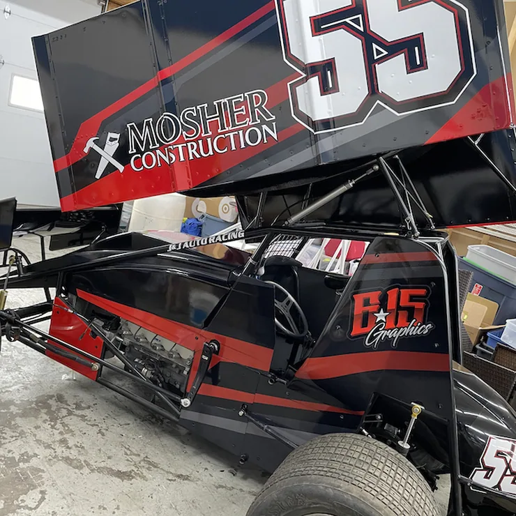 Sprint car with a black and red wrap design, number 55